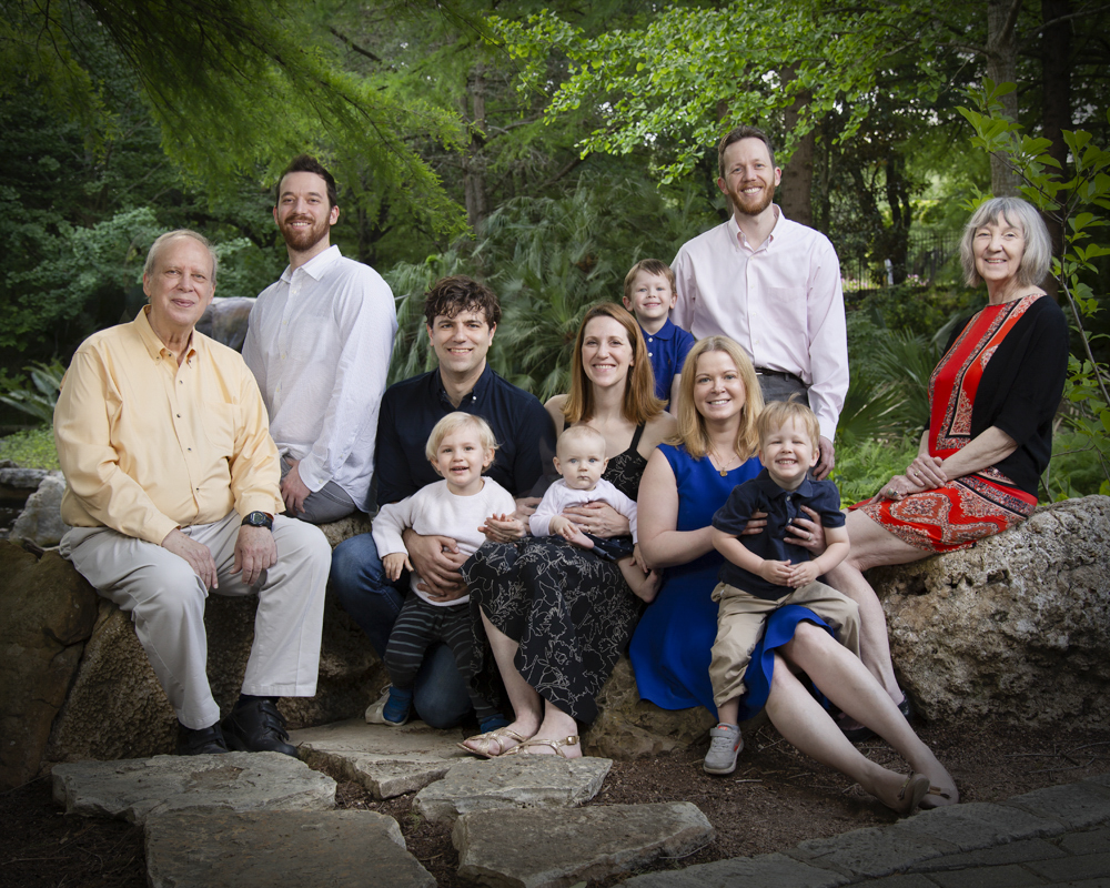 Family portrait in Zilker Botanical Gardens in the jurrasic area